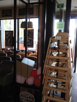 de nombreuses chaises et tables dans un restaurant doté d'une baie vitrée