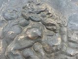 a statue of a man holding a child on a rock