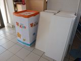a refrigerator and freezer in a room with tile flooring