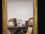 a mirror that is sitting on a shelf in a room