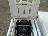 a white refrigerator with the door open on the street