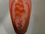a glass vase with a design on it sitting on a table