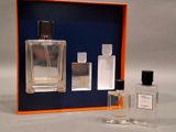 two bottles of perfume sitting next to each other on a table
