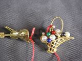 pair of gold tone christmas ornaments with red string and bells