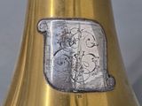 a silver and gold vase with a silver and gold monogram on it