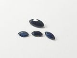 a group of blue sapphires on a white surface