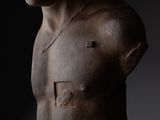 sculpture of a man ' s torso with a hat on top of it