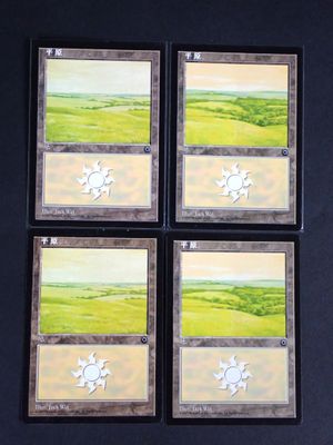 four cards with a picture of a green field and a sun on them