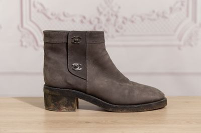 a close up of a pair of boots on a wooden table