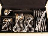a lot of silverware in a box on the table