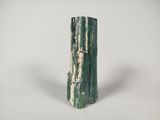 a green vase that is sitting on a white table