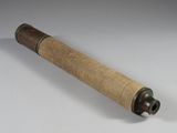 an old telescope with a wooden handle on a table