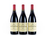 three bottles of red wine sit side by side on a white surface