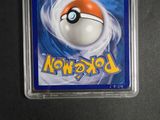 a pokemon card in a plastic holder on a table