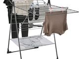 an image of a clothes drying rack with clothes hanging on it