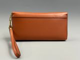 an image of a brown leather purse with a long strap