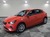 a red car is parked in a room with a checkered floor