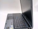 a laptop that is sitting on a white surface