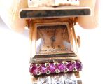 a person holding a watch with a bunch of stones on it