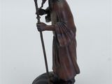 an image of a statue of a man with a staff