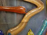 a glass sculpture of a snake and some other items on the table