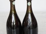 two bottles of wine sitting on top of a marble counter top