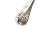 a silver spoon and fork on a white surface