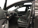 the interior of a car with the door open and the driver ' s seat down
