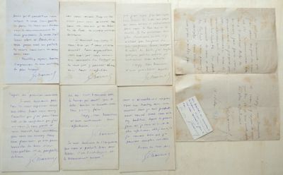 several pieces of old paper with handwriting on them sitting on a table