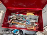 a red tool box filled with assorted tools on the floor