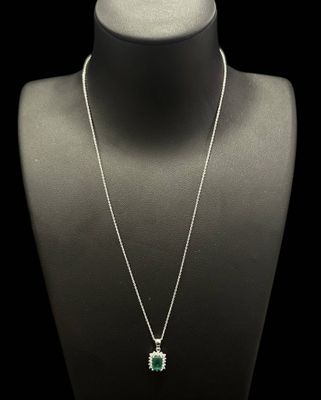 a necklace with an emerald and white topaz stone pendant