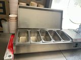 an image of a hot food station with three pans of food in it