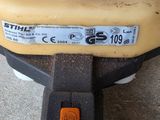 a close up of a yellow and black lawn mower