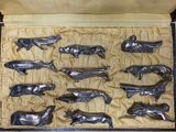 a lot of silver metal animals in a box