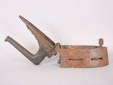 an old rusted metal clamp on a white surface with a white background