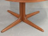 a wooden table with a glass top on a grey floor