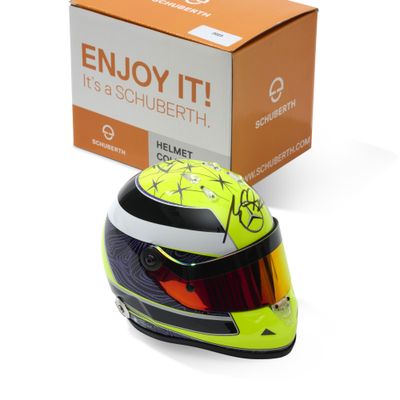 the helmet is yellow and black with a red dot on the vise