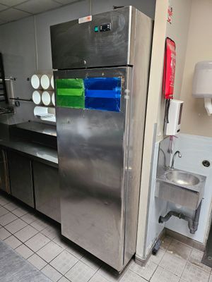 a stainless steel refrigerator in a commercial kitchen