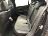 the back seats of a car with a remote control in it