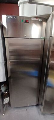 two stainless steel refrigerators sitting next to each other in a room