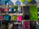 many bags of different colors and sizes of items in the store