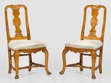 deux chaises en bois avec des assises rembourrées et un coussin blanc