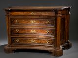 a wooden chest of drawers with gold decorations on it