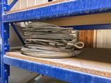 a stack of wires on a blue shelf in a warehouse
