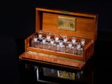 a wooden box with glasses in it on a black surface