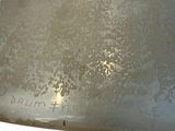 a silver plate with writing on it sitting on a table