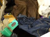 a pile of clothes and other items on the floor
