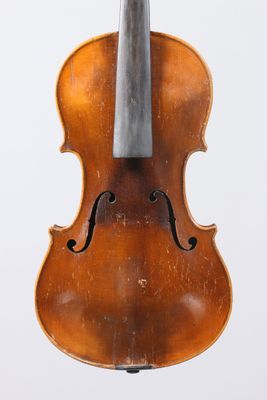 an old violin with a bow hanging from it ' s back