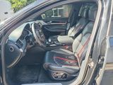 the interior of a car with the door open and the driver ' s seat up