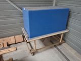 a large blue box sitting on a cart in a garage